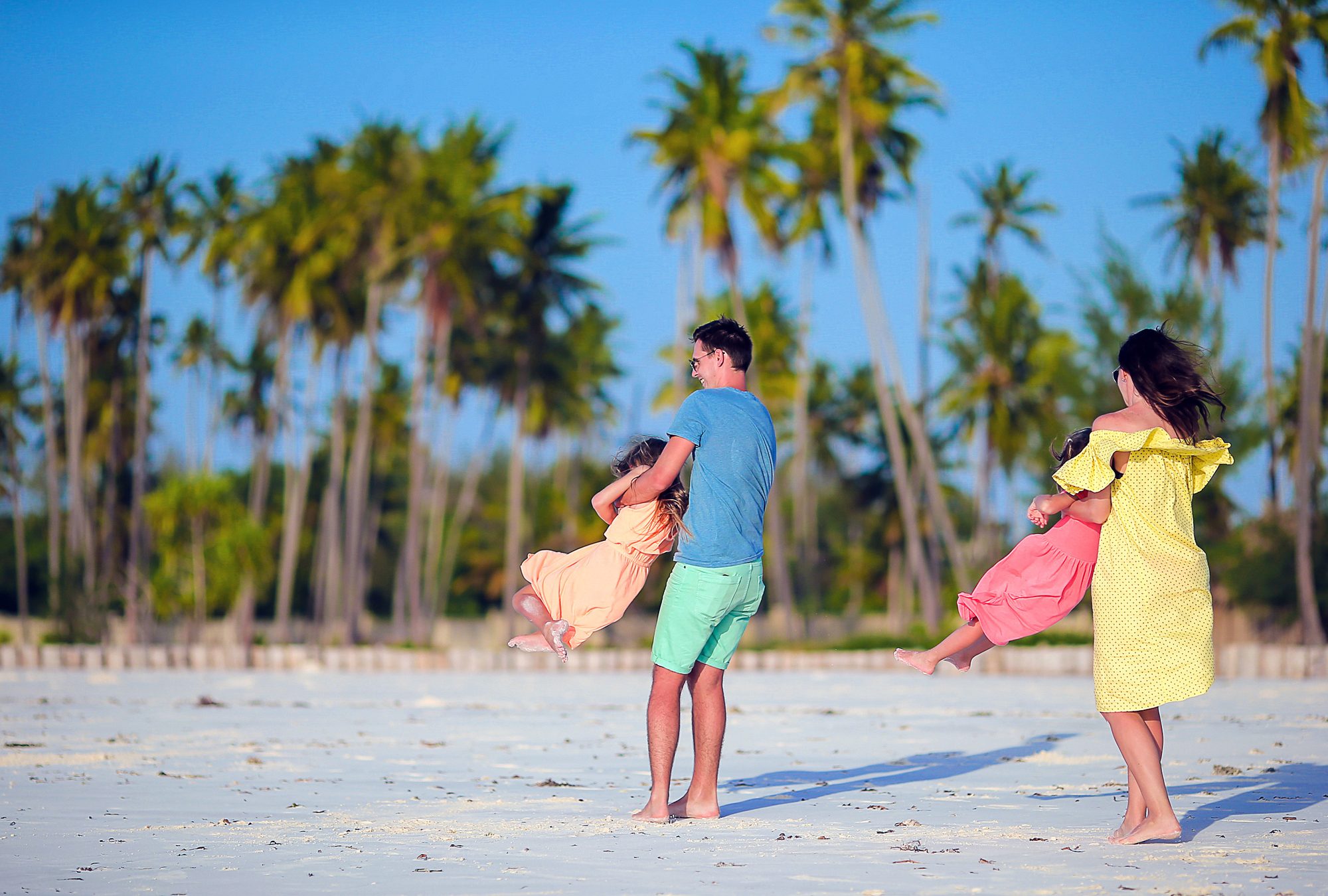 Family enjoying white-sand beach in Zanzibar